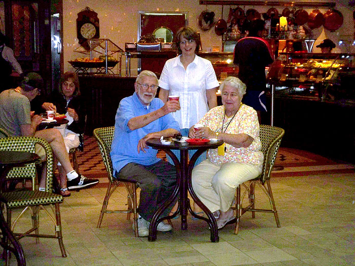 Anna with Mom and Dad at the Promenade Cafe, our favorite people-watching hangout.