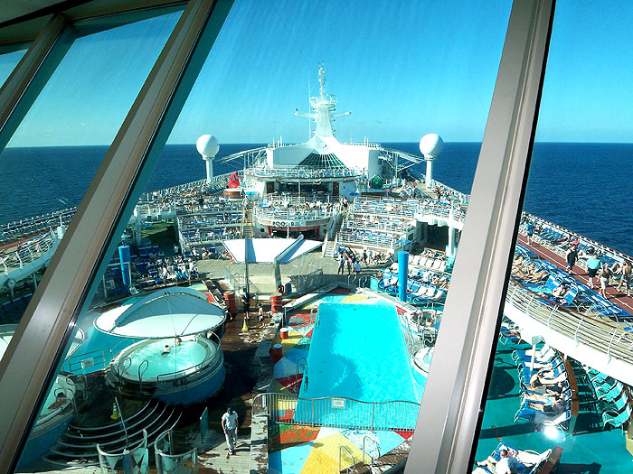 Deck 11 pool, hot tubs and bar from inside the Cosmopolitan Club on Deck 14.